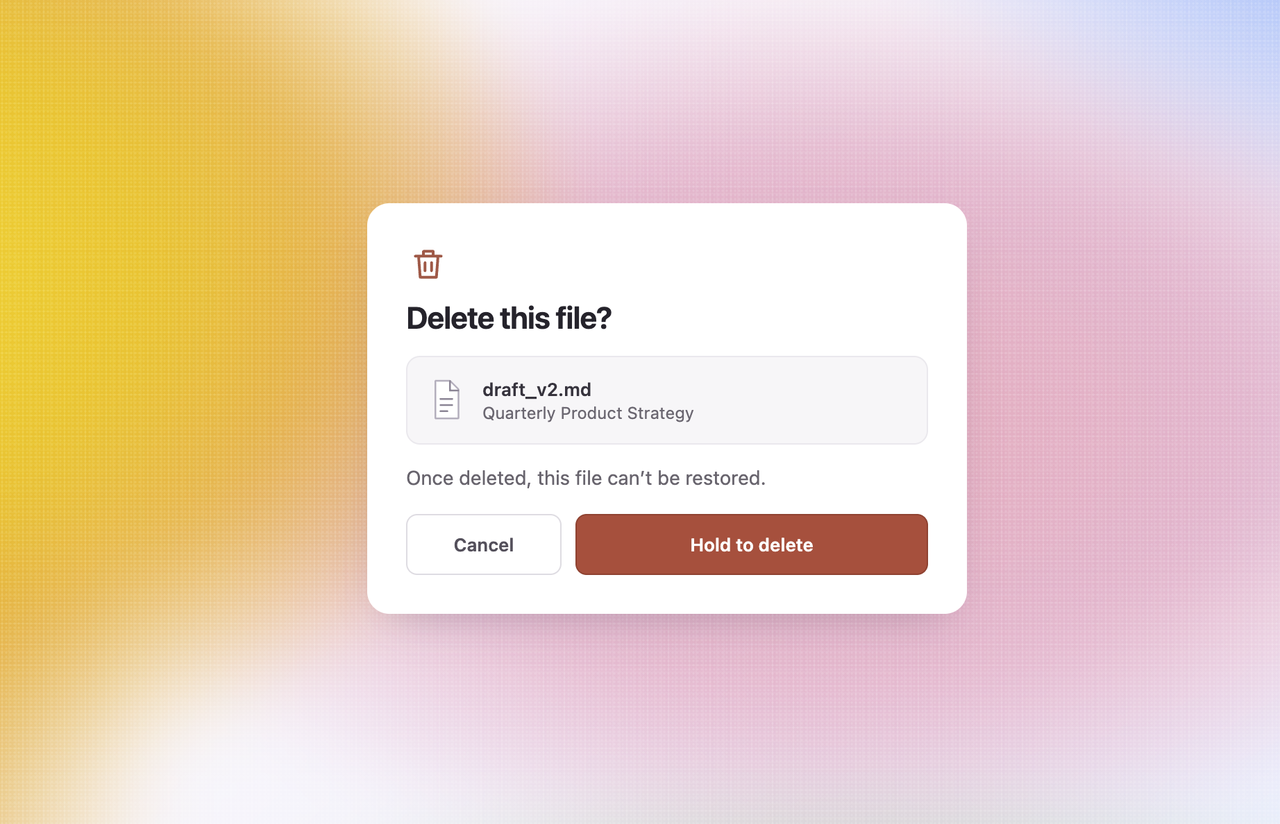 Hold-to-delete confirmation interaction for permanently deleting a file
